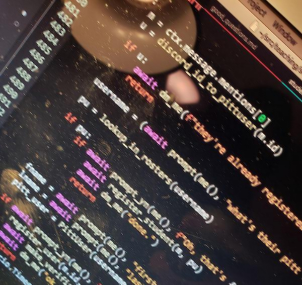 a blurry, tilted phone camera photo of code on a dusty fingerprint-laden laptop screen